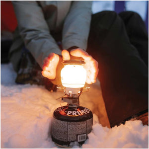 Close-up of Primus EasyLight components with protective plastic case beside it