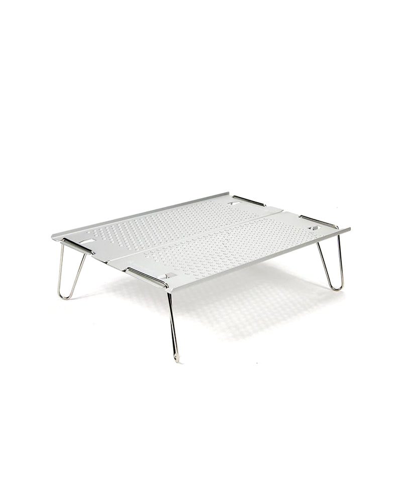 Snow Peak Ozen Solo Table SLV-171 set up, low angle showing perforated top and four splayed stainless wire legs