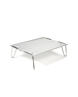 Snow Peak Ozen Solo Table SLV-171 set up, low angle showing perforated top and four splayed stainless wire legs