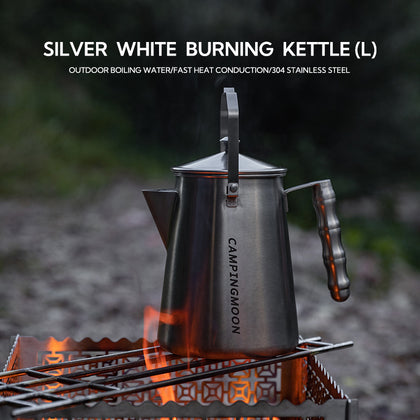 Kettle with heat-resistant handle pouring boiling water outdoors