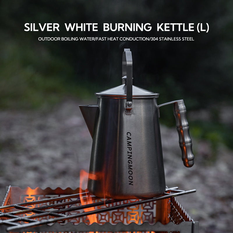 Kettle with heat-resistant handle pouring boiling water outdoors