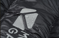Close-up of a raincoat with water droplets on the hood, featuring a brand logo.