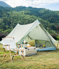 Bell tent in a natural setting with outdoor furniture and supplies.