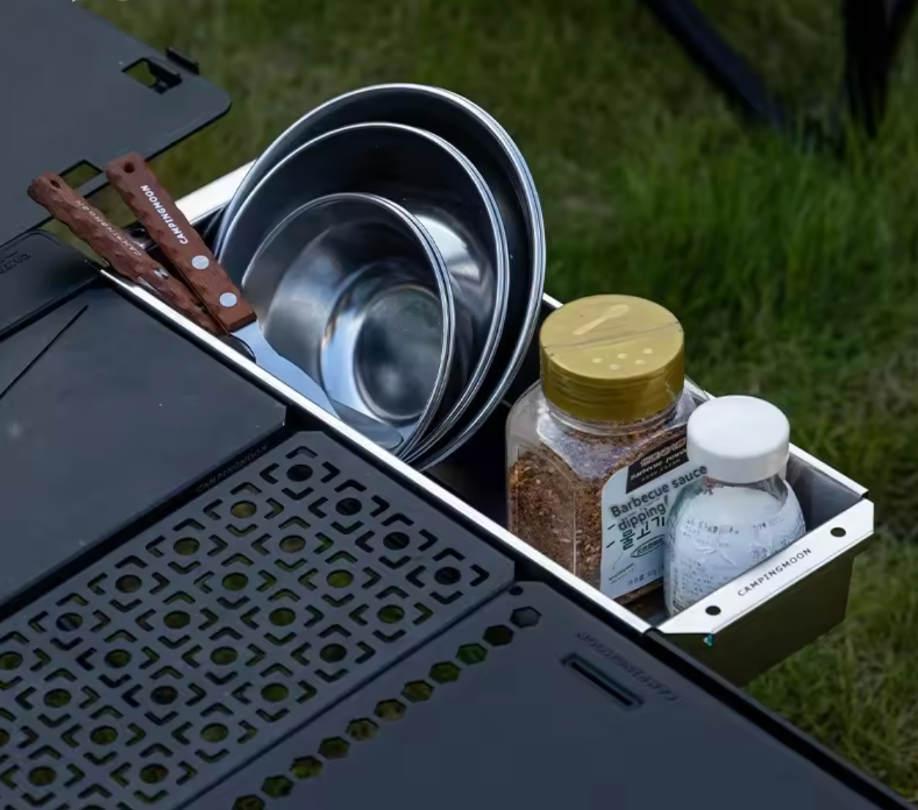 Cooking utensils and ingredients on a portable stove outdoors