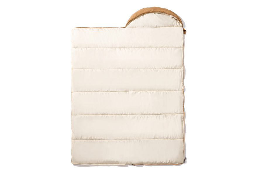 White quilted baby carrier with brown handle on a white background