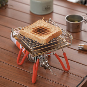Campingmoon US‑1312 bread toaster set up on a camping stove with toast on the grill