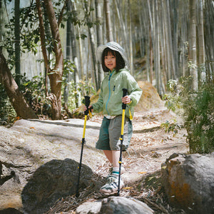 Young hiker using Naturehike Chuxue EXT1 trekking poles on a rocky trail
