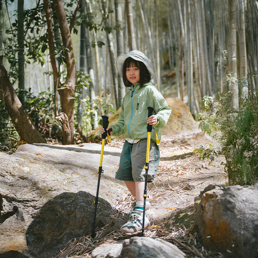 Young hiker using Naturehike Chuxue EXT1 trekking poles on a rocky trail