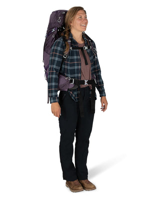Woman wearing the Osprey Aura AG 50 backpack in Enchantment Purple on the trail