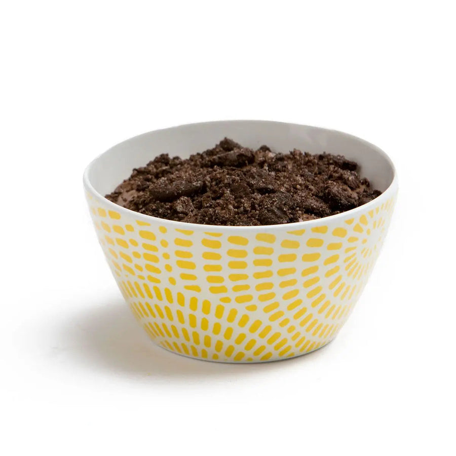 Prepared dark chocolate mousse topped with cookie crumb in a camp bowl
