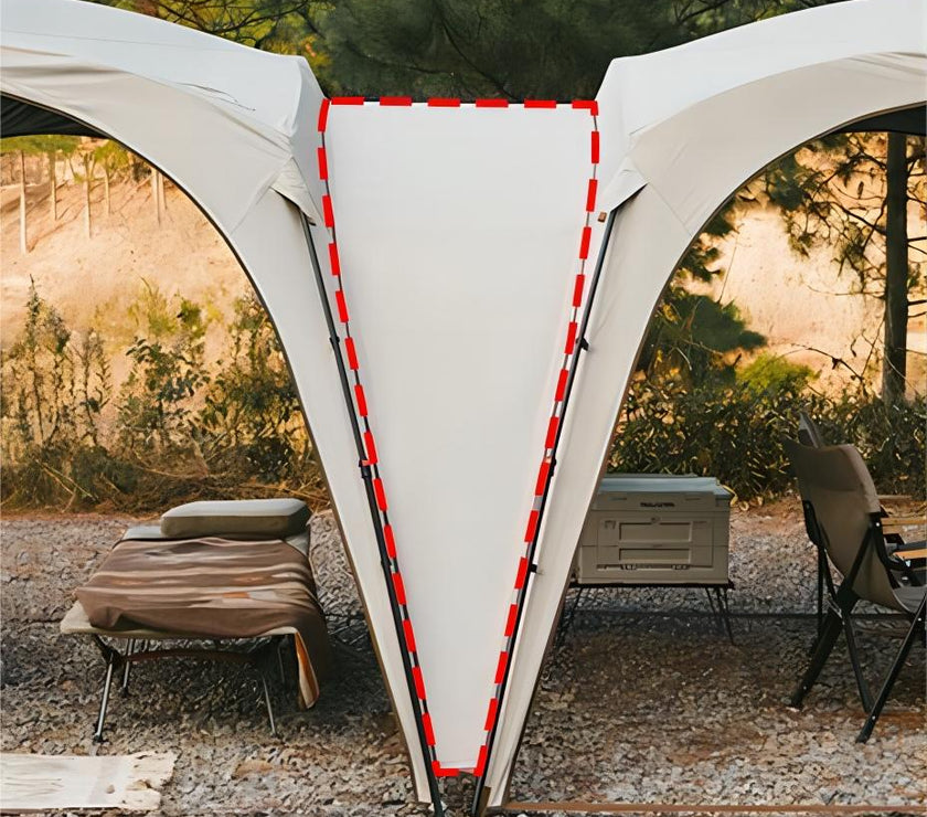 Outdoor canopy tent with lounge chairs and a cooler in a natural setting