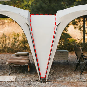 Outdoor canopy tent with lounge chairs and a cooler in a natural setting