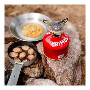 Primus Essential Trail Kit cooking on rocky terrain with pan lid frying inside