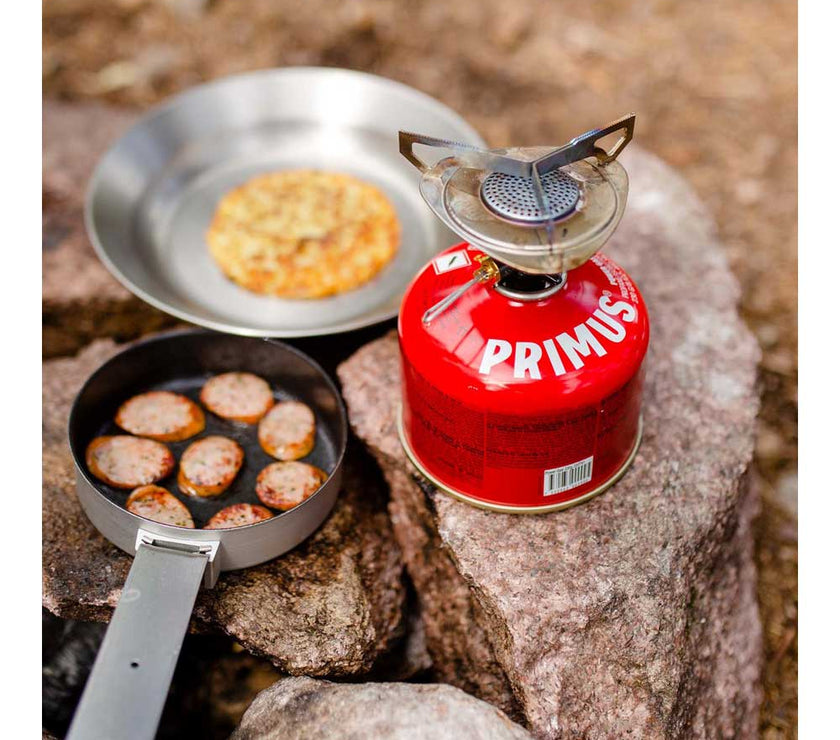 Primus Essential Trail Kit cooking on rocky terrain with pan lid frying inside