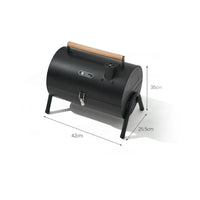 Dimensions labeled on the side of A compact, black two-sided barbecue stove with a wooden handle, designed for outdoor cooking activities like camping and picnics.