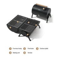 A compact, black two-sided barbecue stove with a wooden handle, designed for outdoor cooking activities like camping and picnics. Shows opened 