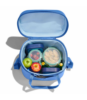 Blue lunch bag with food containers and apples on a white background
