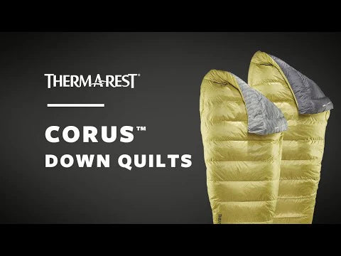 Yellow down quilt with gray lining on a black background.