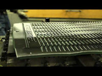 Close-up of a metal grate or grille, possibly on a vehicle.