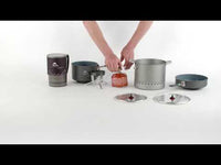 Person setting up camping cookware on a white background