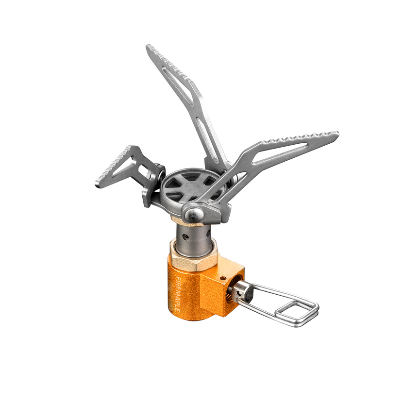 A compact and foldable Fire Maple camping stove made of titanium, featuring an orange color and foldable design for portability.