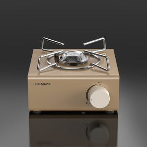A compact Fire Maple butane gas stove with a stainless steel pot stand and a gold aluminum alloy body.