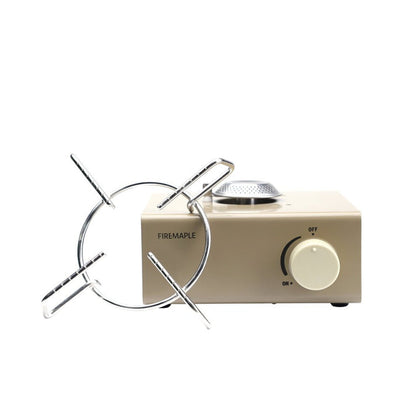 A compact Fire Maple butane gas stove with a stainless steel pot stand and a gold aluminum alloy body.