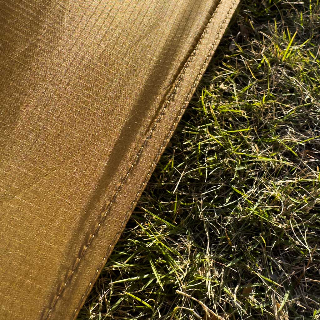 Close-up of the silicone-coated 20D fly fabric and taped hem