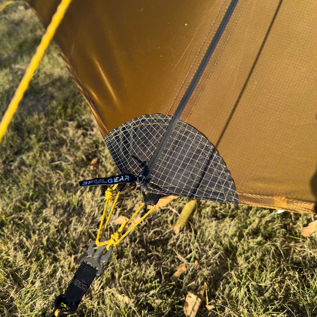 Reinforced guy-out point with tensioner, staked into grass