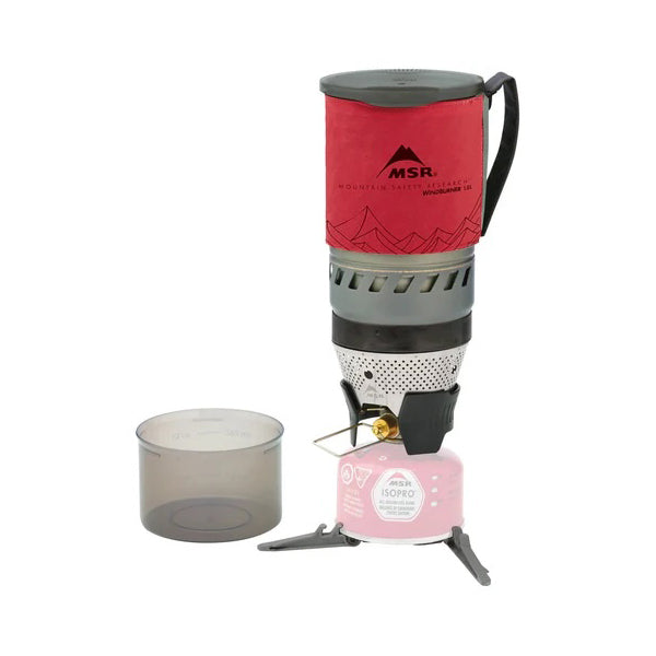 MSR WindBurner 1.0L camping stove system with a red top, silver body, and a gray pot placed on a pink fuel canister.