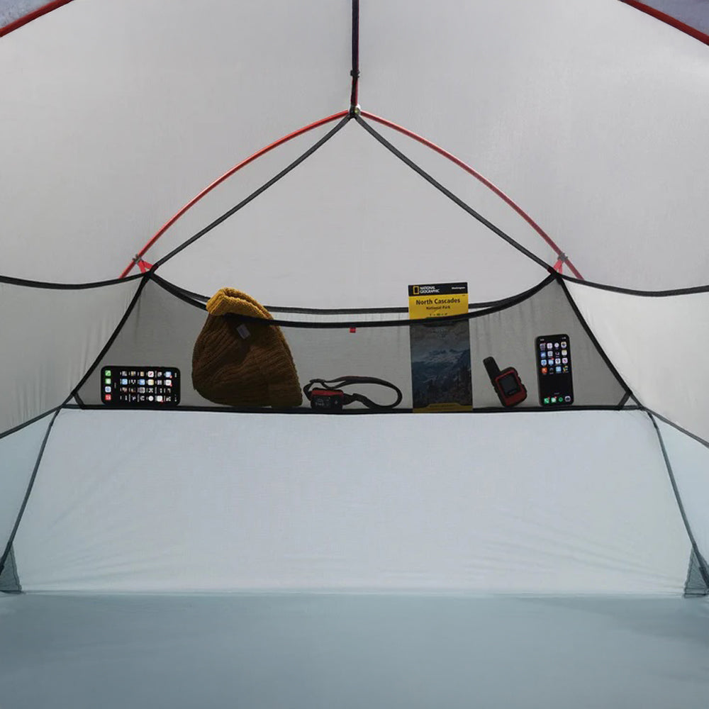 Inside of a tent with various items on a shelf