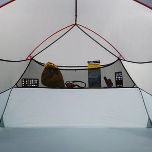 Inside of a tent with various items on a shelf