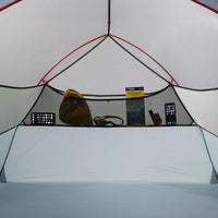 Inside of a tent with various items on a shelf