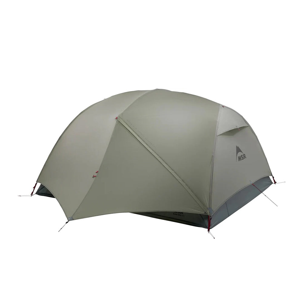 A green MSR Hubba Hubba LT 3P Tent set up outdoors with a visible flysheet and pole structure.