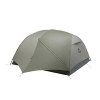 A green MSR Hubba Hubba LT 3P Tent set up outdoors with a visible flysheet and pole structure.