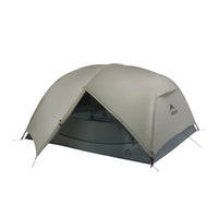 Green camping tent on a white background
