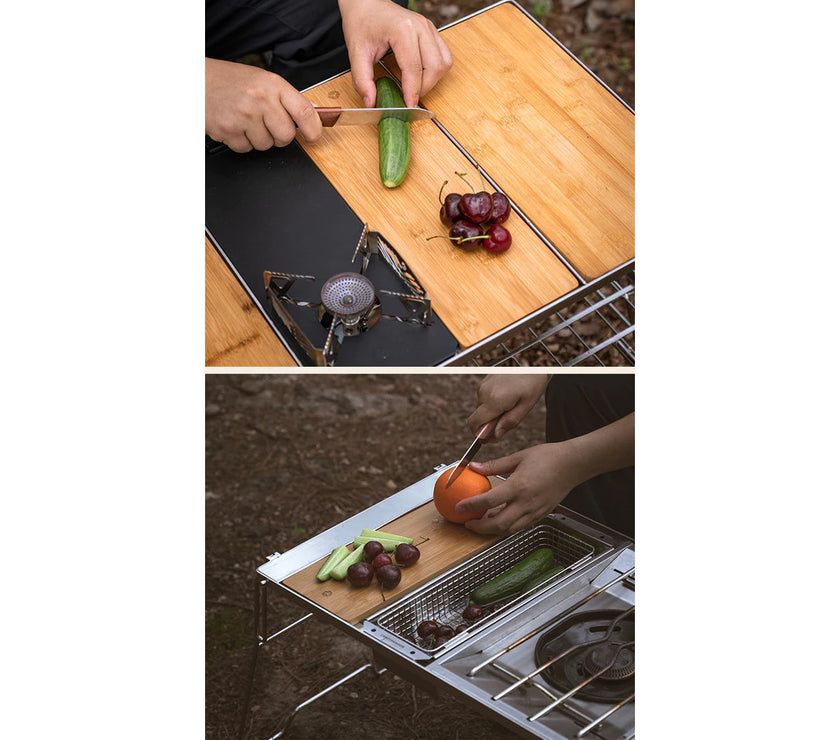 Person cutting vegetables on a portable outdoor cooking setup with a stove and grill.