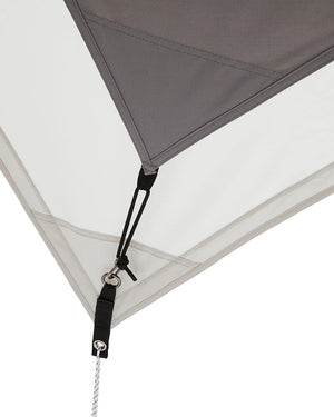 Snow Peak Takibi Tarp Hexa Set M corner: grey inner roof clipped to the ivory tarp's steel O-ring by an adjustable black cord